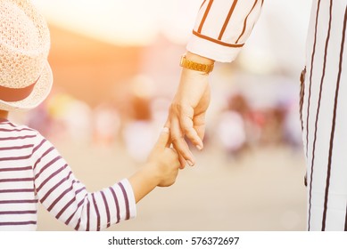 Mother holding a child's hand - Shutterstock ID 576372697