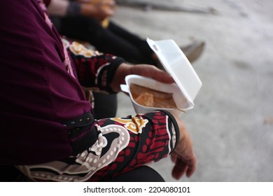 A Mother Holding Chinese Food With Box.