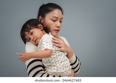 mother holding and comforting her crying toddler baby  - Powered by Shutterstock