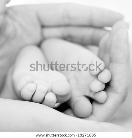 Mother holding her child's feet, b&w shot