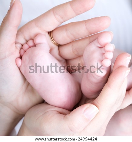 Mother holding her child's feet