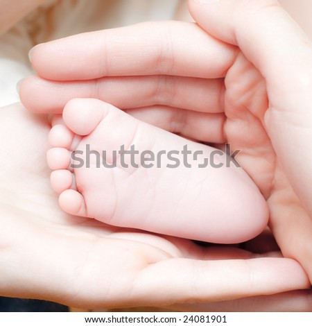 Mother holding her child's foot