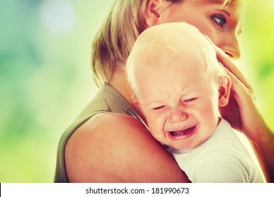 Mother Holding Her Crying Baby