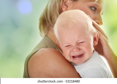 Mother holding her crying baby