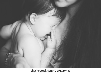 Mother Holding Her Crying Little Baby. Black And White Photo. Pain With Teething