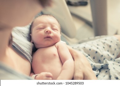 Mother holding her new born baby boy.  - Shutterstock ID 1045289503