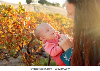 A Mother Holding Her New Born Baby On A Farm With The Sun Behind Them, Showing Love And Connection