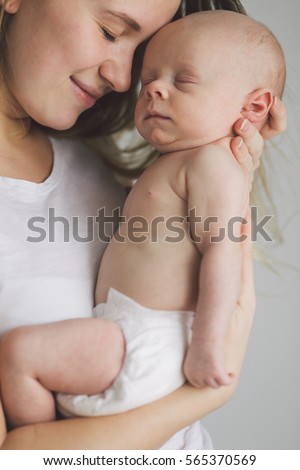 Similar – Mother hugging her newborn baby girl