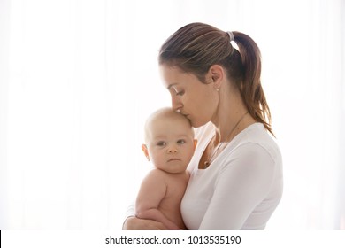 Mother, Holding Her Sick Baby Boy, Sad Baby, Isolated On White Background 