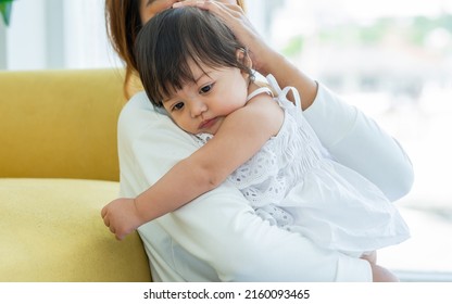 Mother Holding And Hugging Adorable Caucasian Little Baby Daughter, Playing Together, The Girl Get Sick, Sleeping Staying In Comfortable Living Room At Home. Family And Kid Concept