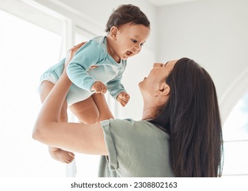 Mother holding laughing baby in home for love, care and quality time together to nurture childhood development. Happy mom, carrying and playing with infant girl kid for support, happiness and fun - Powered by Shutterstock