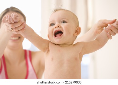 Mother Holding Out Baby Girl's (9-12 Months) Arms, Close-up