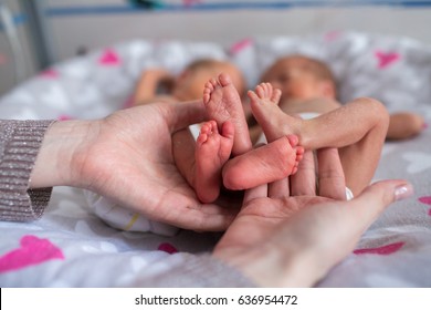 Mother Holding Premature Twins Legs