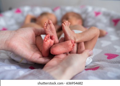 Mother Holding Premature Twins Legs