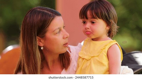 Mother holding sad infant girl - Powered by Shutterstock