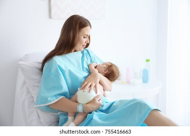 Mother Holding Sleeping Baby At Hospital