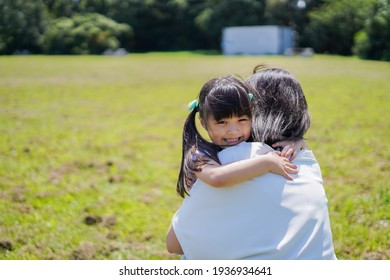 Mother Holding A Small Child In Her Arms