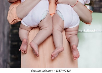 Mother Holding Twin Babies