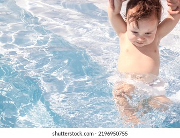 Mother Holds Baby From Hands Let Him In Pool Water Sunny Summer Day Vacation Sea.women Holding Up Child Hands Teach To Swim.happy Joyful Fat Toddler Infant.feeling Safe Have Fun Free Space