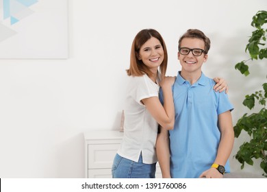 Mother Hugging Her Teenager Son At Home
