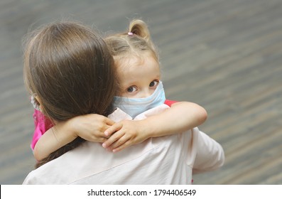 A Mother Hugs Her Little Daughter Before School . Concept Of Care, Education And Training.