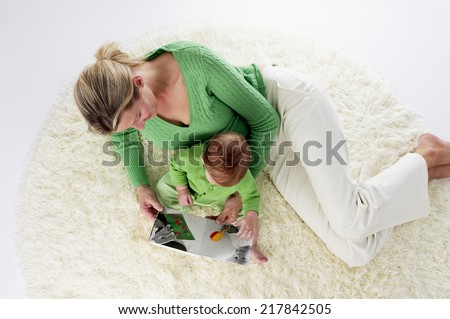Mother and Infant Laying on Rug, Overhead Angle