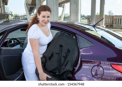 Mother Installing Child Restraint Seat In The Car