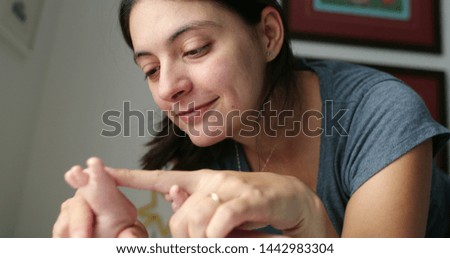 Similar – Happy girl using a smart phone sitting on a couch at home