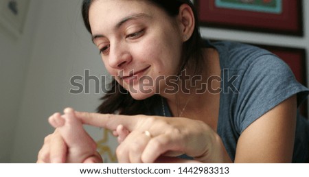 Similar – Happy girl using a smart phone sitting on a couch at home