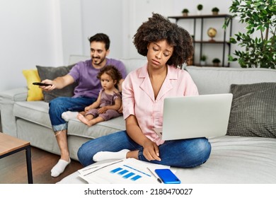 Mother Of Interracial Family Working Using Computer Laptop At Home Looking Sleepy And Tired, Exhausted For Fatigue And Hangover, Lazy Eyes In The Morning. 