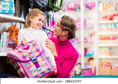Mother And Kid Becoming A Student Buying School Satchel Or Bag In Store