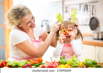 Mother And Kid Cooking And Having Fun In Kitchen