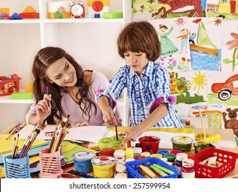 Mother With Kid  Painting  In School. Education.