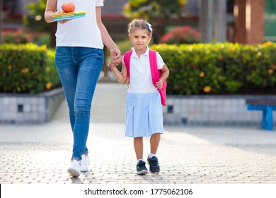 Mother And Kids After School. Young Mom Picking Up Children After Lessons In Kindergarten Or Preschool. Pick Up Students. Boy And Girl Running To Parents In School Yard.