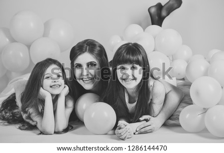 Mother and kids in balloons, mothers day. mother and children in pink birthday balloons