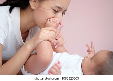 Mother Kiss Baby's Feet That Touch Of Love