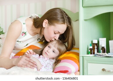 Mother Kisses The Sick Child