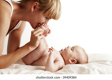 Mother Kissing Baby Feet