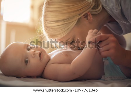 Similar – Mother hugging her newborn baby girl