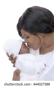 Mother kissing her one-month-old baby girl, isolated