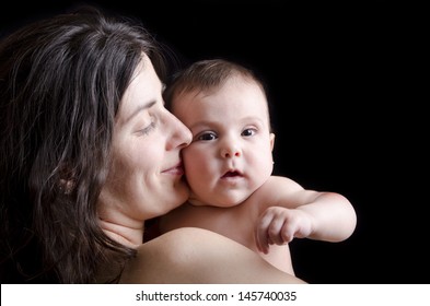 Mother Kiss.Mother And Baby On Black Background