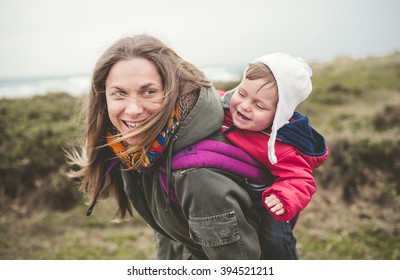 Mother Laughing And Having Fun With Your Toddler Outdoors