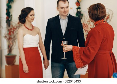 Mother In Law Pronouncing Toast To Happy Newlywed Couple, Woman With Champagne Glass Drinking To Bride And Groom At Wedding Ceremony In Registry Office