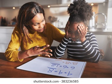 Mother Learning Her Daughter To Calculate Elementary School Work