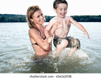 Mother Lifting Child In River