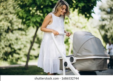 Mother with little baby daughter walking in park
