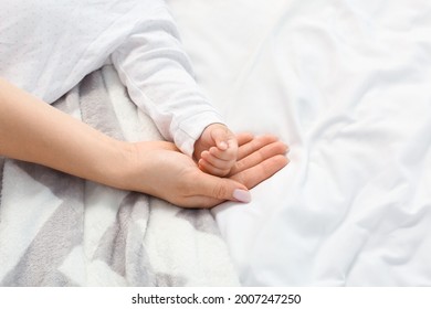 Mother with little baby sleeping on bed - Shutterstock ID 2007247250