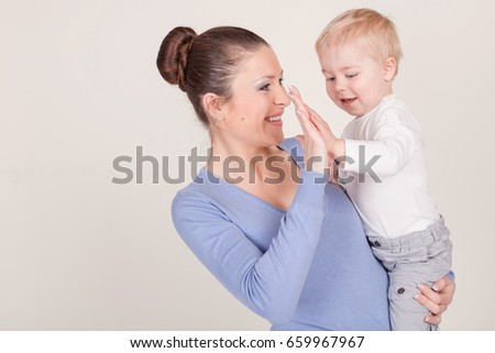 mother and little boy play show lodon' Kiss