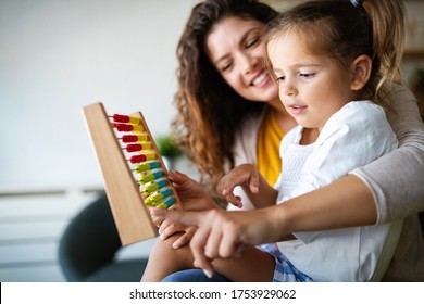 Mother and little cute girl, kid playing with abacus, early education - Shutterstock ID 1753929062