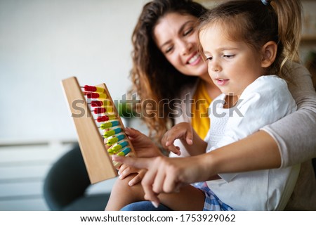 Mother and little cute girl, kid playing with abacus, early education